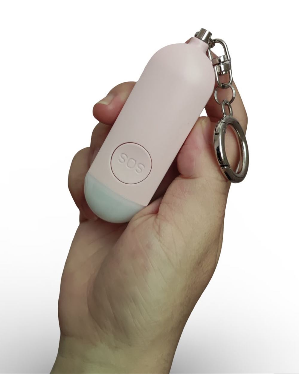 The Baby Pink Hera alarm held in a hand, showing the SOS button, frosted light and silver key ring