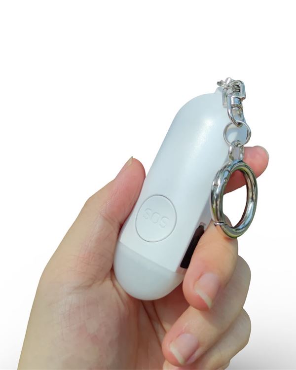 Pearl White Hera alarm held in a hand, key ring hooked on a finger